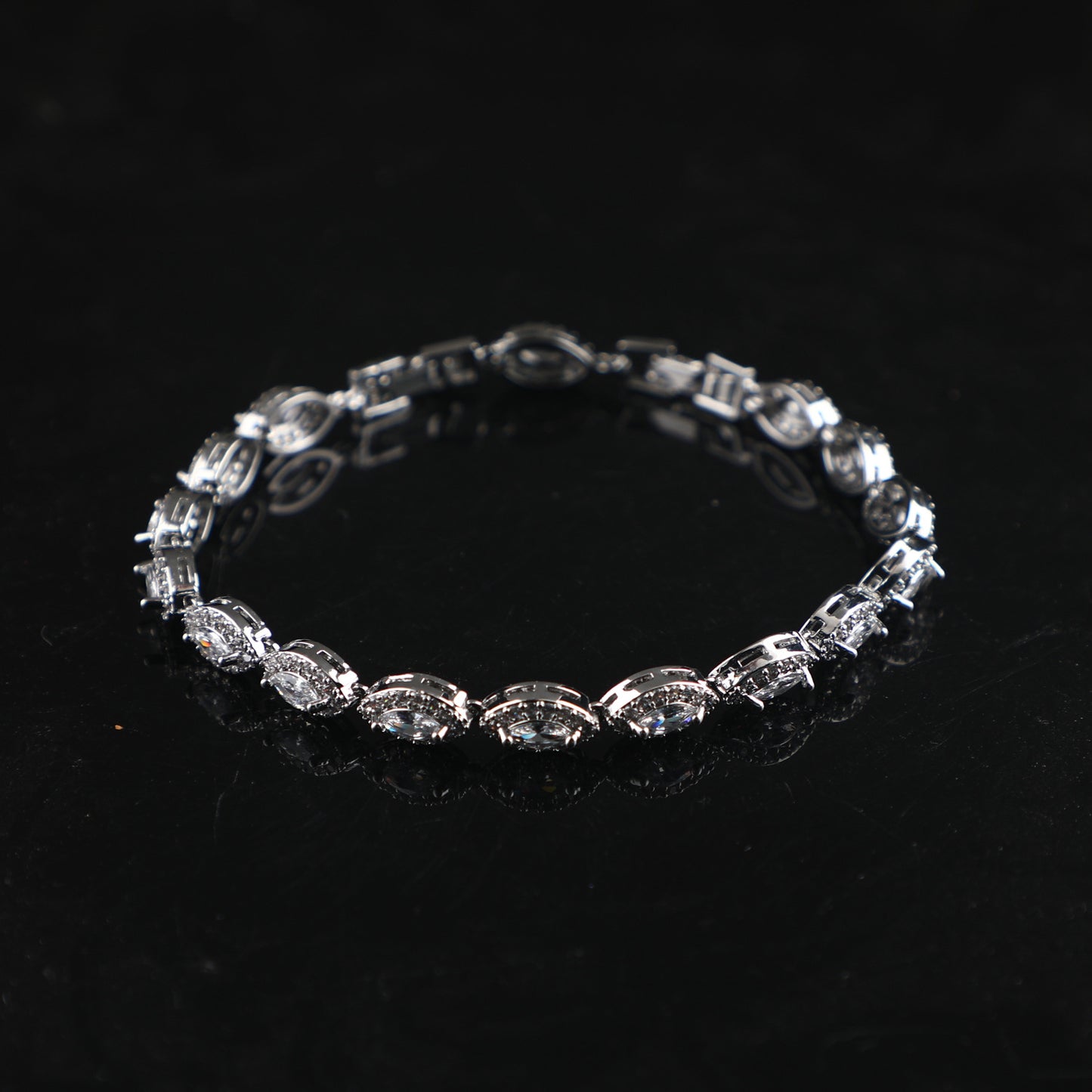 Silver bracelet with gemstone details.
